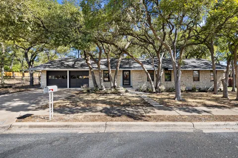 front view of a house with a tree