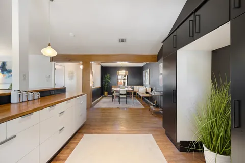 a view of a kitchen with kitchen island granite countertop lots of counter top space
