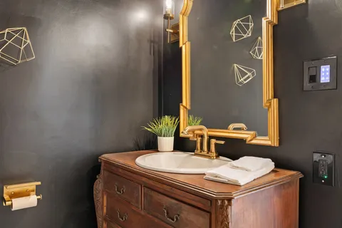 a bathroom with a sink toilet and mirror
