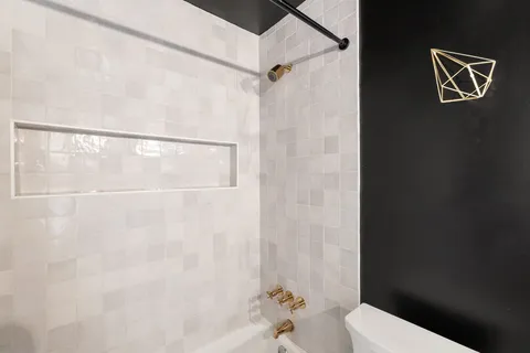 a bathroom with a window and a shower
