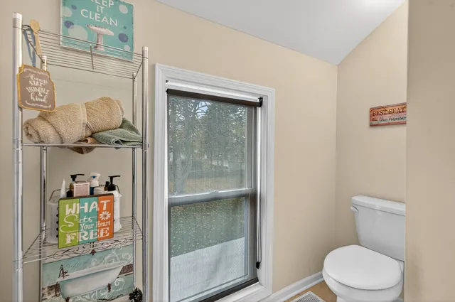 a white toilet sitting next to a bathroom sink