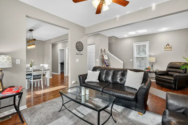 a living room with furniture a wooden floor and a chandelier