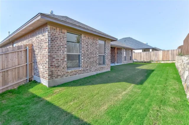 a view of a house with a yard and porch