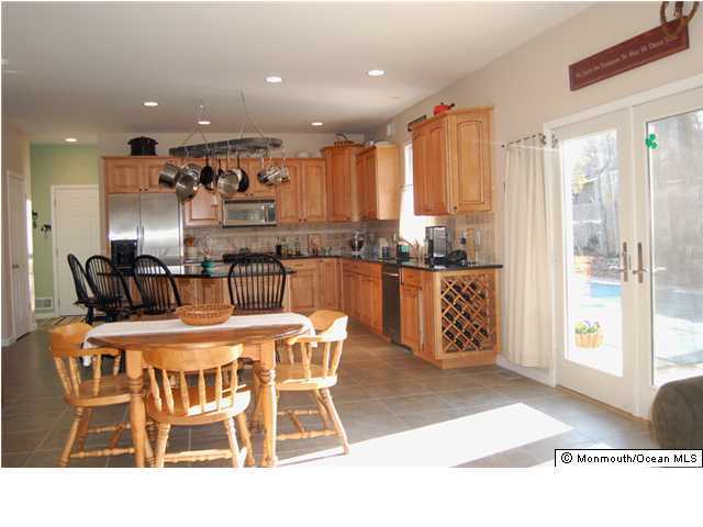 2567 High Point Road Manasquan, NJ 08736 - Photo 2 of 3 a dining hall with stainless steel appliances granite countertop a table and chairs
