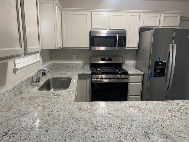 8320 Hobhouse Circle Raleigh, NC 27615 - Photo 6 of 16 a kitchen with a refrigerator stove and microwave