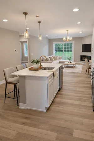 a large kitchen with a sink and living room view