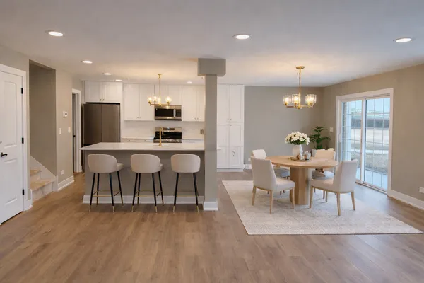 a dining room with furniture and wooden floor