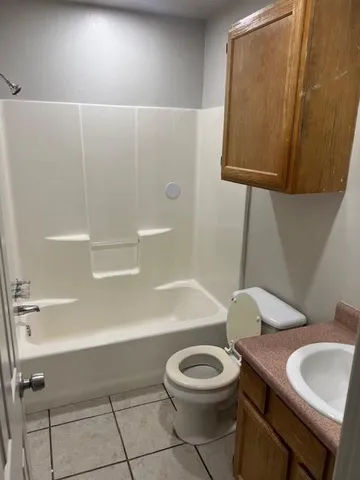 a bathroom with a toilet a sink and bathtub