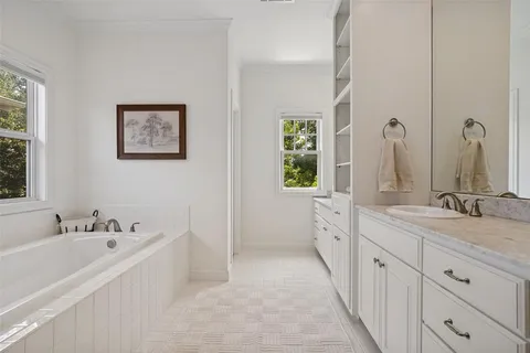 a bathroom with double vanity sink and a mirror