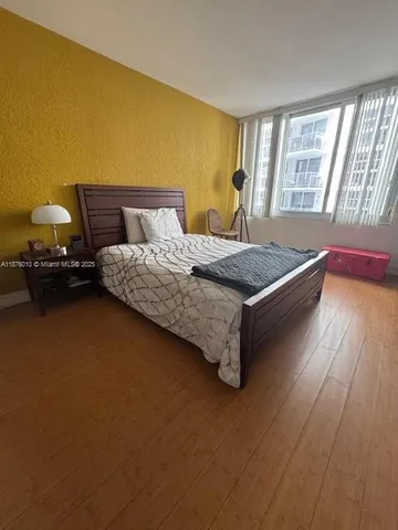 a spacious bedroom with a bed and window