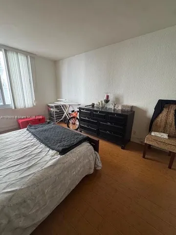 a bedroom with bed and window