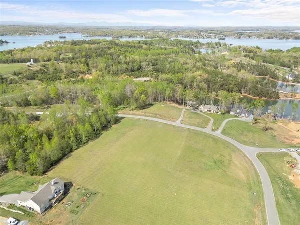 a view of green field with mountains in the background