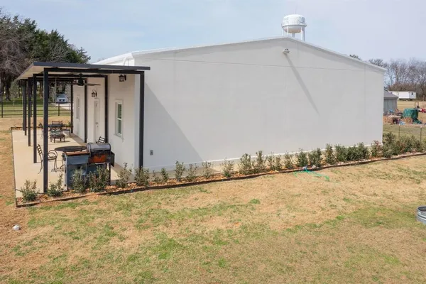 a living room with furniture kitchen view and a chandelier