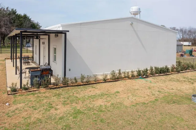 a living room with furniture kitchen view and a chandelier