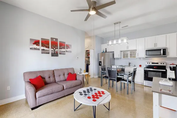 a kitchen with stainless steel appliances a sink stove refrigerator and cabinets