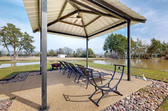a view of a swimming pool with outdoor seating