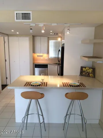 a kitchen with stainless steel appliances a stove a sink and a refrigerator