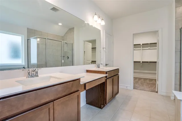 a bathroom with a sink double vanity and a mirror