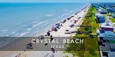0 Crystal Beach Road Crystal Beach, TX 77650 - Photo 15 of 18 This aerial photo showcases Crystal Beach in Texas, featuring a long stretch of sandy coastline lined with beach houses. The area is bustling with activity, including beachgoers and vehicles, highlighting a lively beachfront community perfect for seaside living.