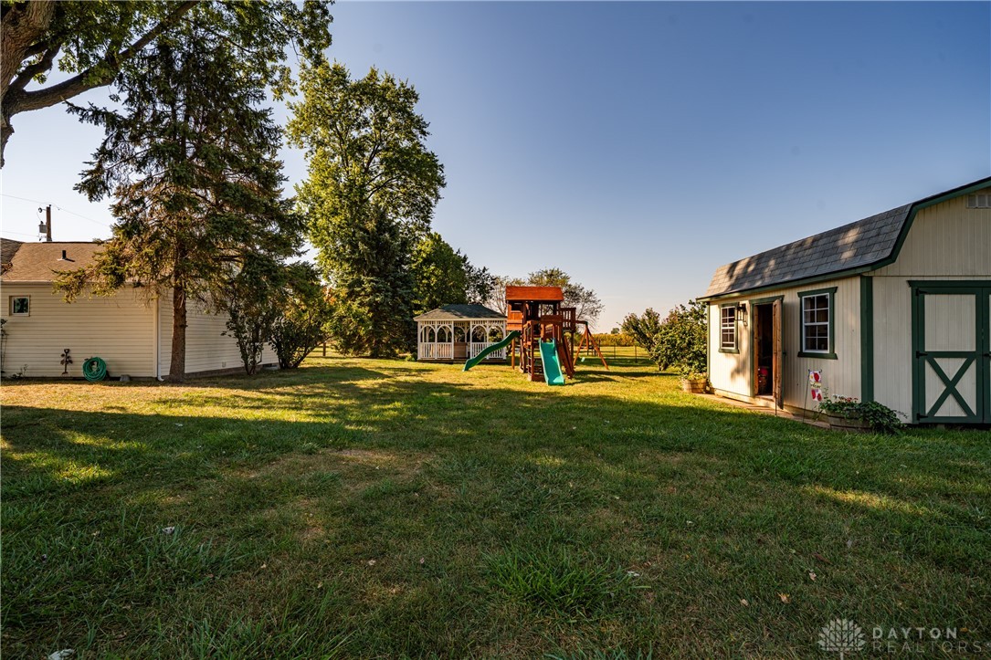 1599 Garringer Road Jamestown, OH 45335 - Photo 52 of 73 This spacious backyard features a gazebo, playground, and storage shed, perfect for outdoor enjoyment.