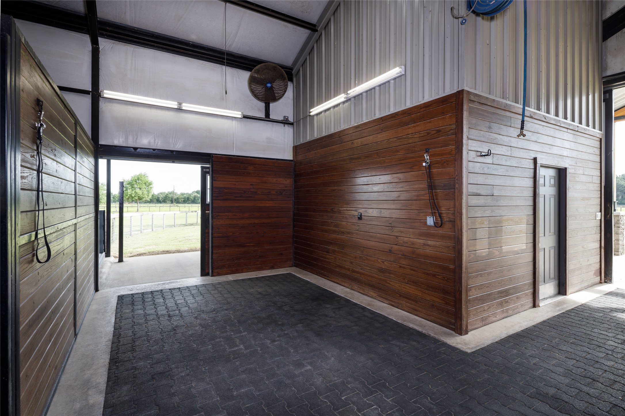 24118 Margerstadt Road Hockley, TX 77447 - Photo 36 of 46 The wash bay was designed to support everyday equestrian use with hot and cold water access, durable finishes, and open space for post-ride care and grooming. Positioned directly within the barn layout, the area allows the facilities to function efficiently while remaining connected to the overall flow of the equestrian spaces.