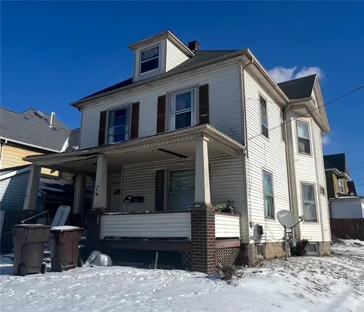 a front view of a house with a barbeque