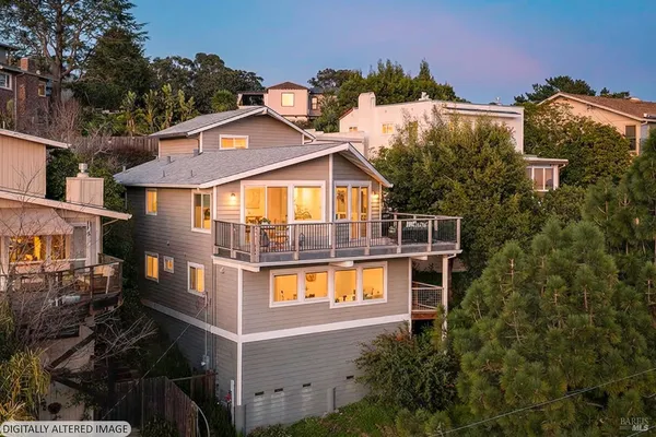 a view of a house with yard and sitting area