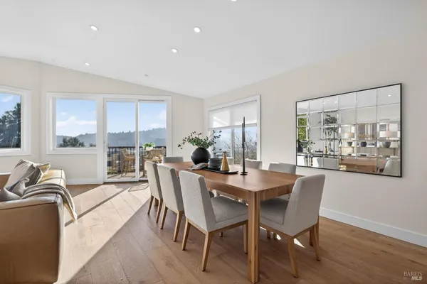a kitchen with stainless steel appliances white cabinets and a window