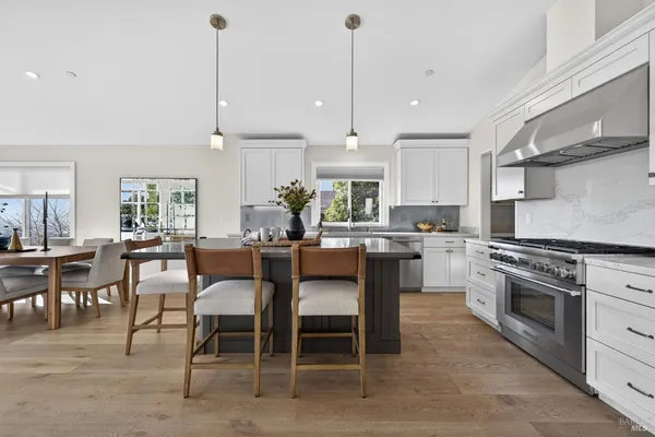 a view of cabinets a oven and wooden floor