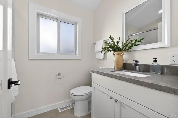 a bedroom with bed and a potted plant