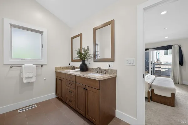 a kitchen with stainless steel appliances white cabinets and a stove top oven