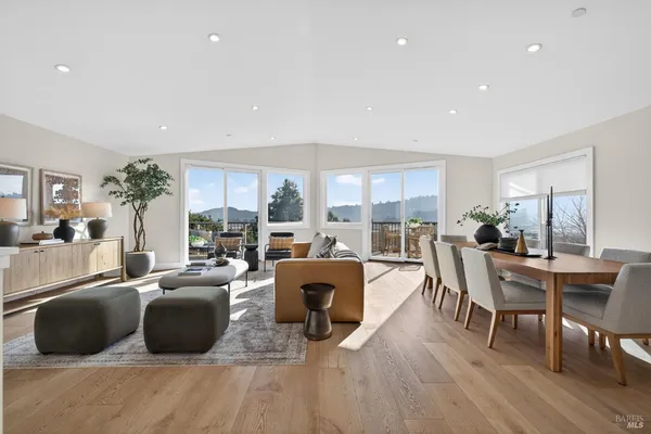 a living room with furniture large window and a table