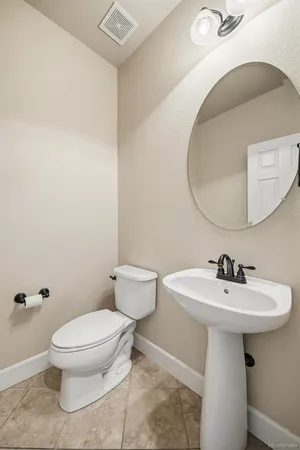 a bathroom with a sink toilet and a mirror