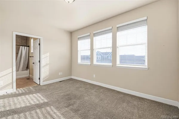an empty room with windows and closet