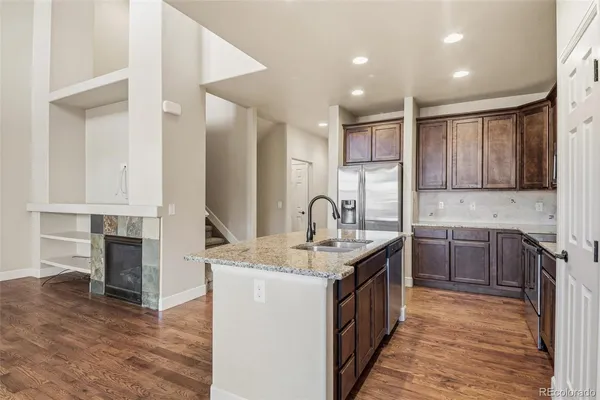 a kitchen with stainless steel appliances granite countertop a sink stove and cabinets