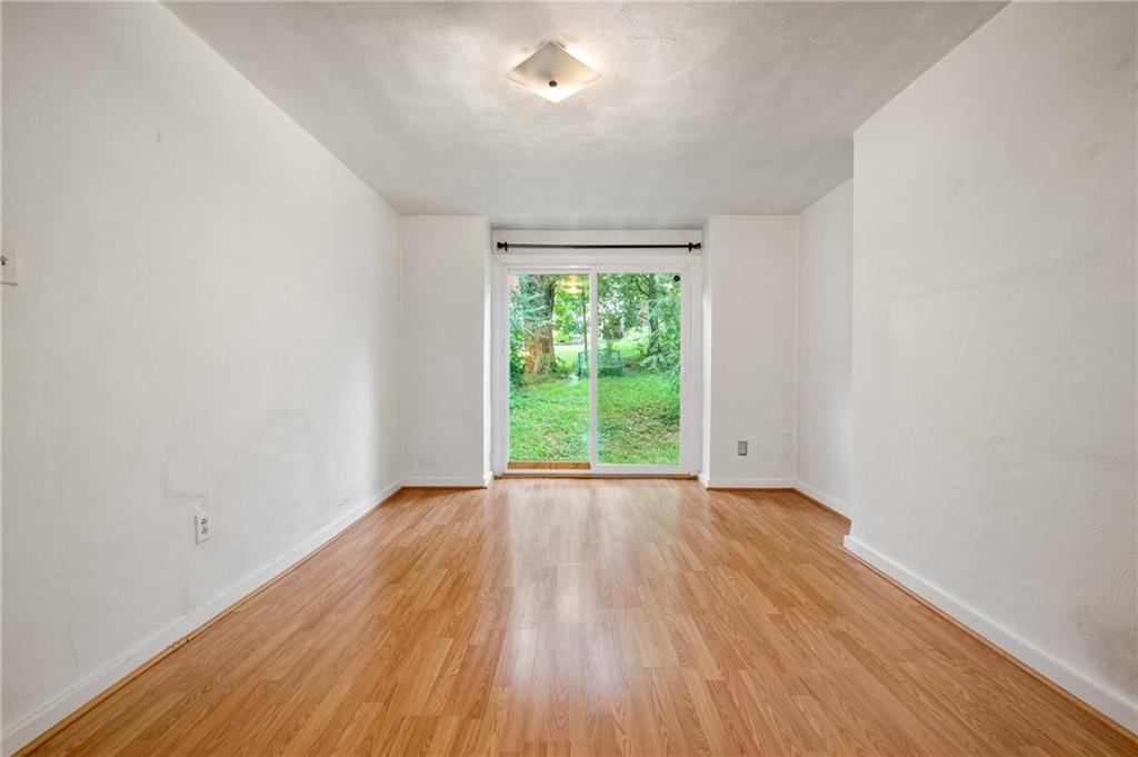 823 Lilac Street, Unit 1 Greenfield, PA 15217 - Photo 11 of 20 an empty room with wooden floor and windows