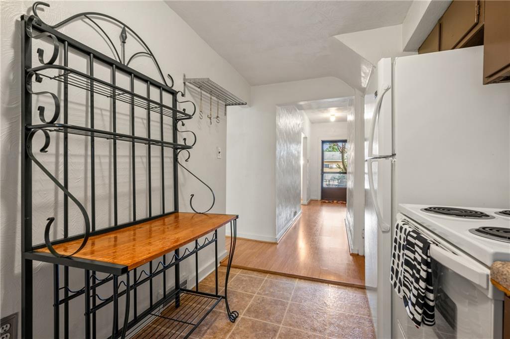 823 Lilac Street, Unit 1 Greenfield, PA 15217 - Photo 15 of 20 a hallway with a stove top oven and refrigerator