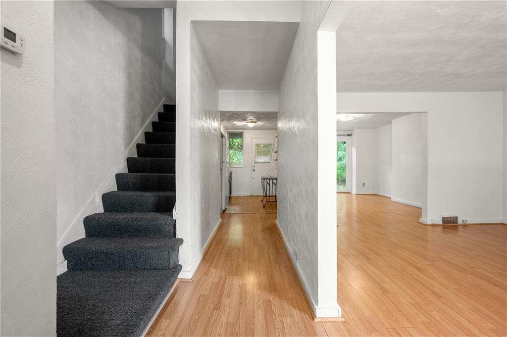 823 Lilac Street, Unit 1 Greenfield, PA 15217 - Photo 6 of 20 a view of a hallway with wooden floor and staircase