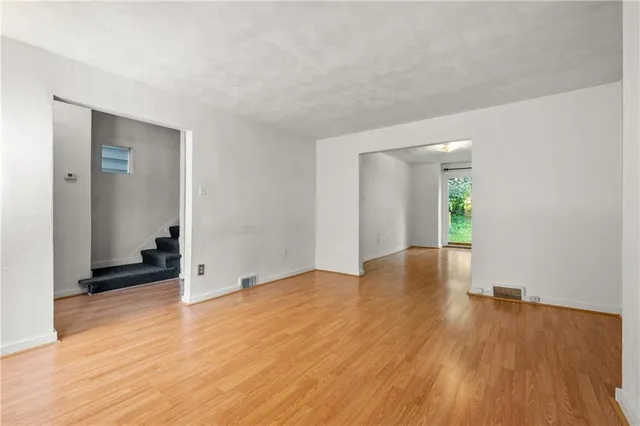 wooden floor in an empty room with a window