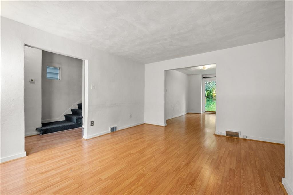 823 Lilac Street, Unit 1 Greenfield, PA 15217 - Photo 9 of 20 wooden floor in an empty room with a window