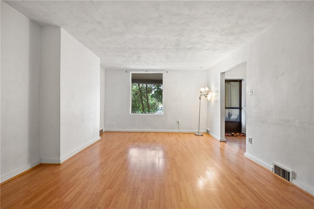 823 Lilac Street, Unit 1 Greenfield, PA 15217 - Photo 10 of 20 an empty room with wooden floor and a window