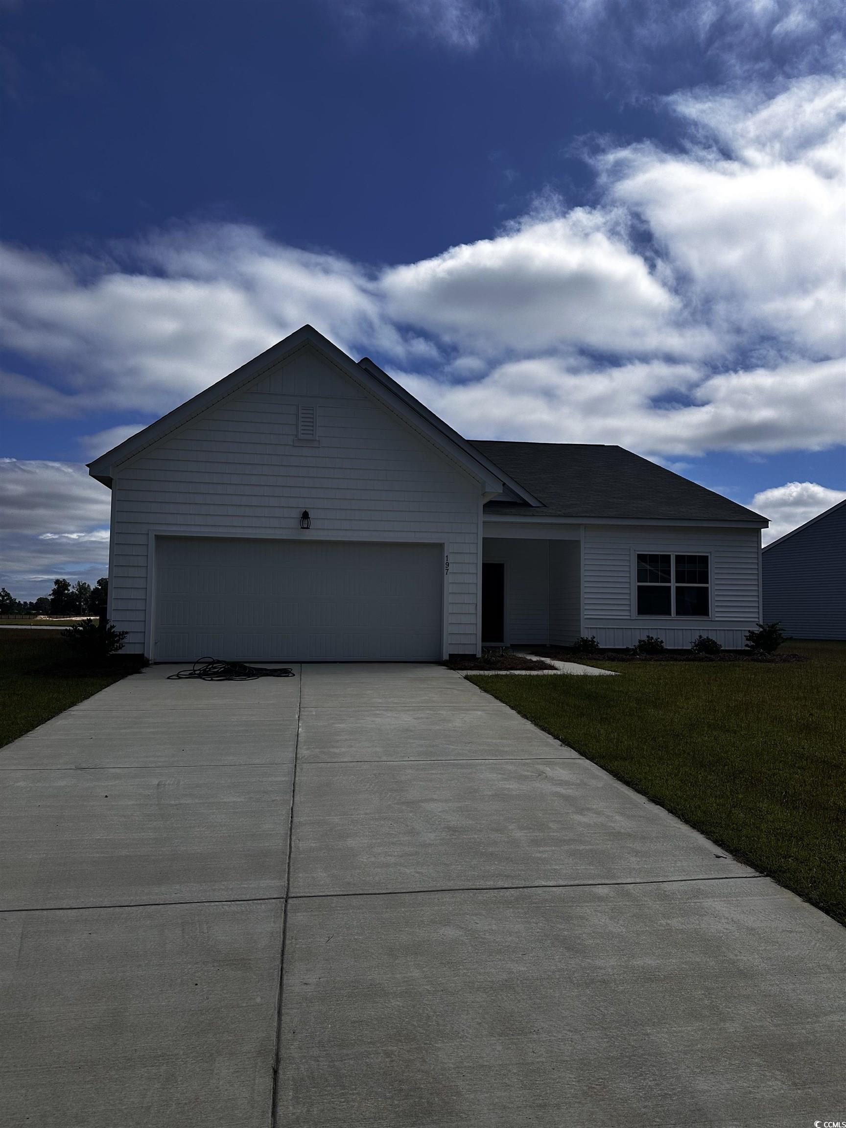 Ranch-style house with a front yard and a garage