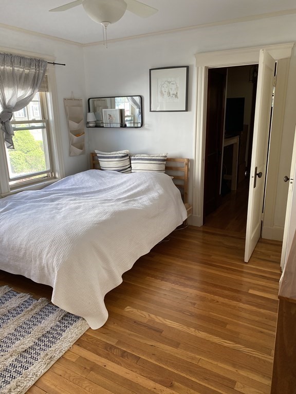 44 Webster Street, Unit 1 Arlington, MA 02474 - Photo 11 of 15 a bedroom with a bed and wooden floor