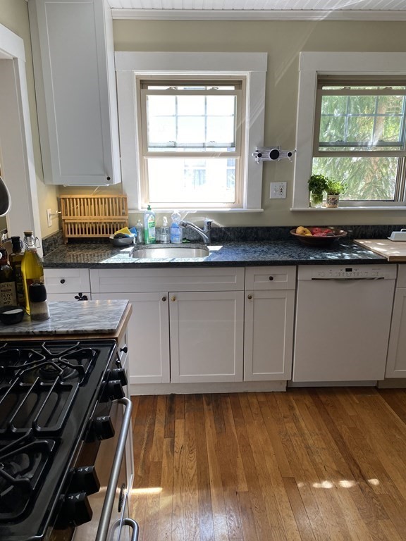 44 Webster Street, Unit 1 Arlington, MA 02474 - Photo 4 of 15 a kitchen with granite countertop a stove and a sink
