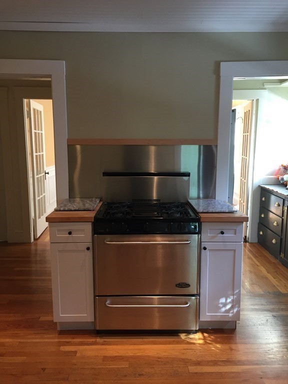 44 Webster Street, Unit 1 Arlington, MA 02474 - Photo 6 of 15 a stove top oven sitting inside of a kitchen