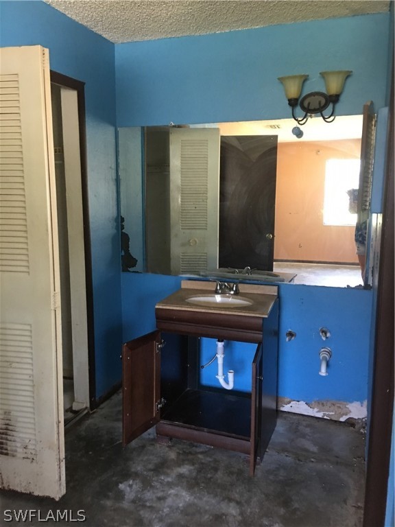 7229 Myrtle Road Fort Myers, FL 33967 - Photo 11 of 15 a bathroom with a sink and a mirror