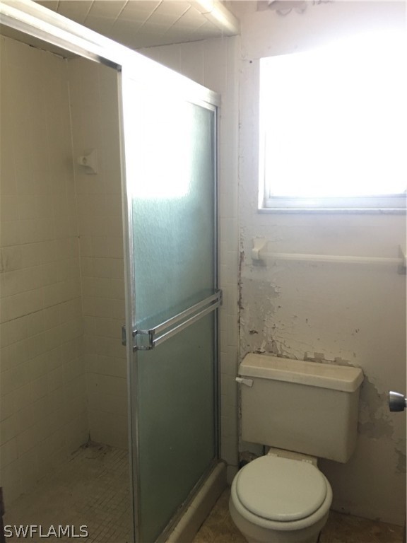 7229 Myrtle Road Fort Myers, FL 33967 - Photo 12 of 15 a white toilet sitting next to a window