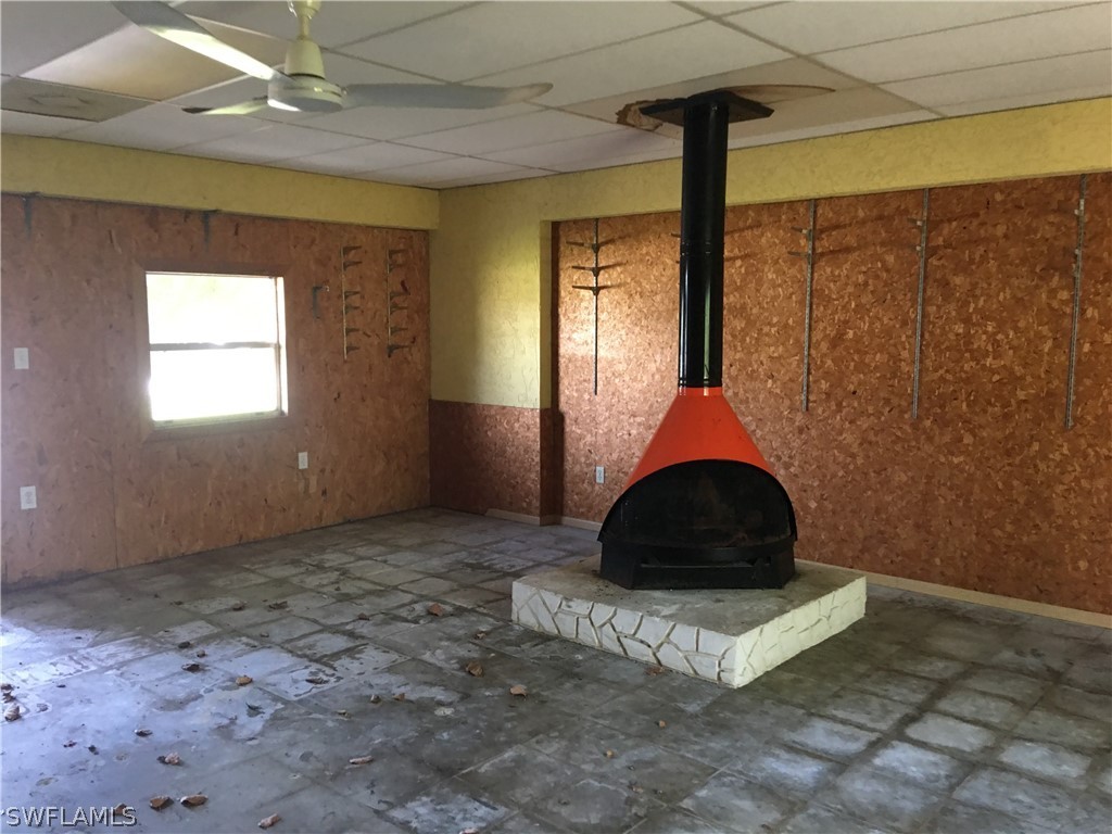 7229 Myrtle Road Fort Myers, FL 33967 - Photo 14 of 15 a room with a large window and chandelier fan