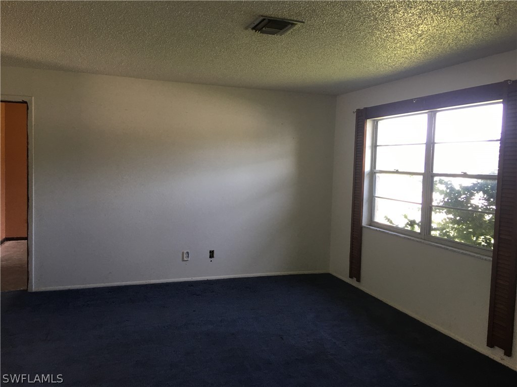 7229 Myrtle Road Fort Myers, FL 33967 - Photo 4 of 15 an empty room with a window