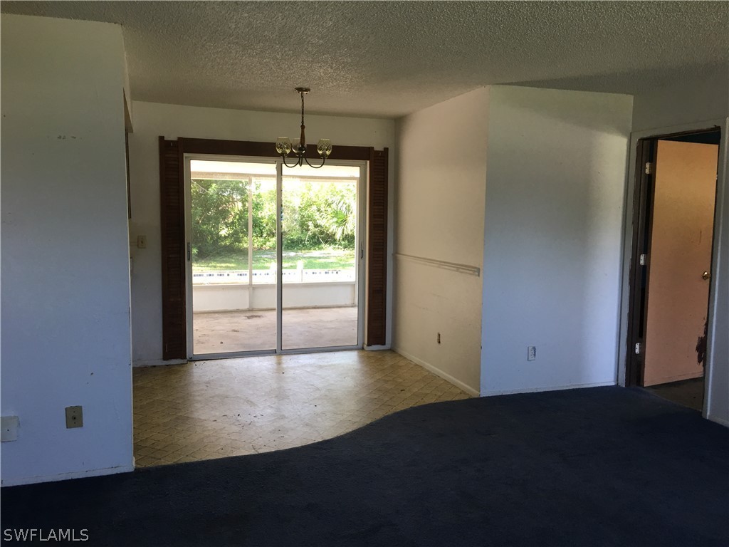 7229 Myrtle Road Fort Myers, FL 33967 - Photo 5 of 15 wooden floor in an empty room with a window